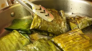 Bhetki Paturi wrapped in banana leaves, coated with mustard paste